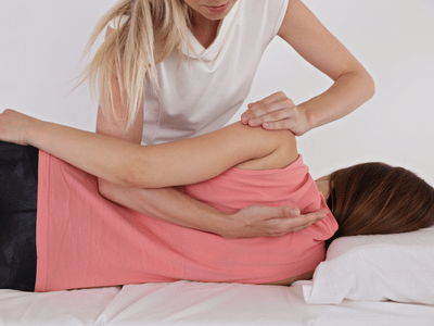 Pracitioner performing osteopathic massage on a patient