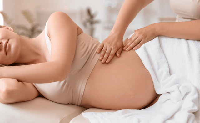 A cozy massage therapy room with supportive cushions and an adjustable table, designed for prenatal care at Everest Therapeutics in downtown Vancouver.