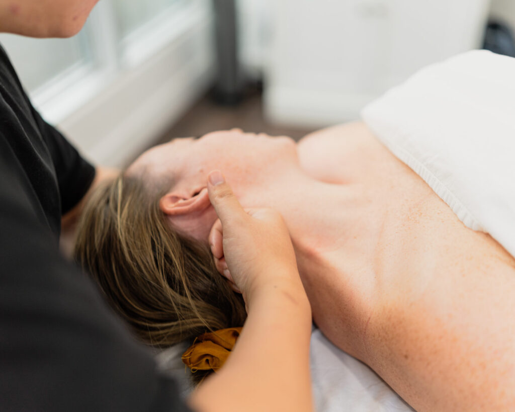 Prenatal RMT massaging a client’s shoulders to alleviate tension headaches in downtown Vancouver.