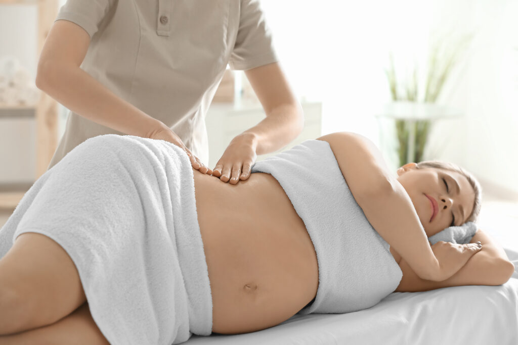 Registered prenatal massage therapists in Vancouver helping pregnant client with sciatica pain